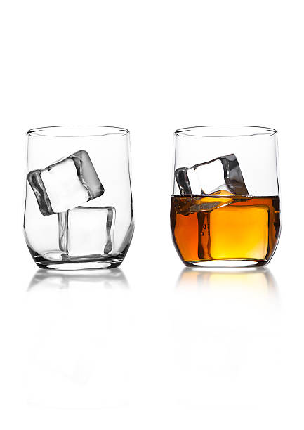 istock Glasses with whiskey and ice cubes on white 615278512