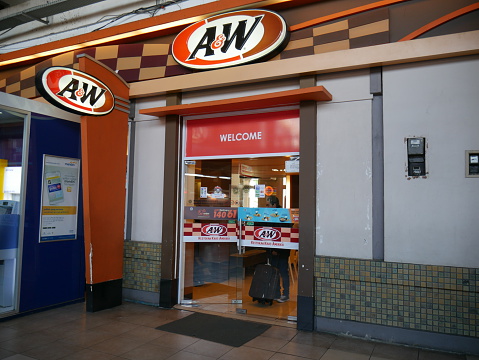 Jakarta, Indonesia - September 29, 2016: Front view of A&W restaurant located in Jakarta Railway station, Indonesia. People are inside the shop and around the area.