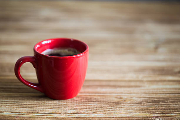 istock Cup of coffee on wooden table, top view 615279338