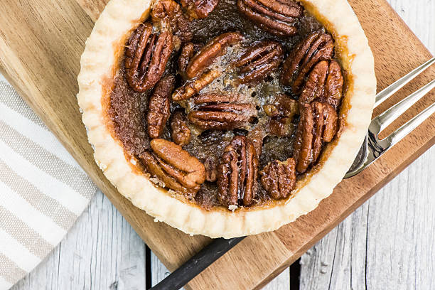 istock Pecan tart on the wooden cutting board 615280278
