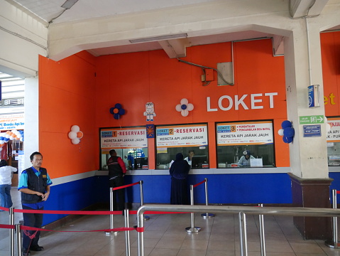 Jakarta, Indonesia - September 29, 2016: Train ticket office inside of Main railway station, Jakarta Kota Station located in the Old Town area. It is a main railway station in Jakarta. People are around the area.