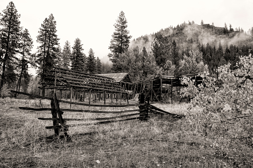 A B&W of an old rundown barn and fence in Okanogan county in Washington near Winthrop.