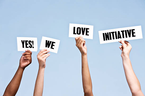 "yes! we love initiative" say hand-held signs - impetus imagens e fotografias de stock