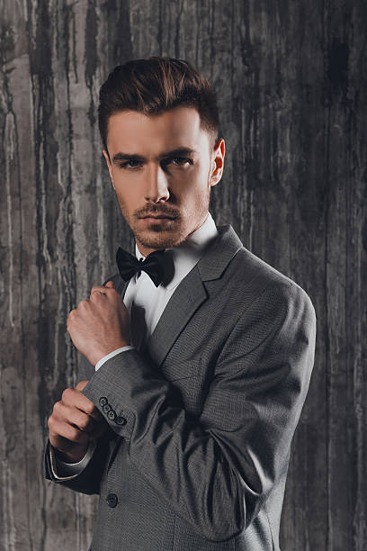 istock Confident man with a bow-tie fastening sleeves 615282172