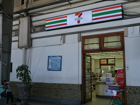 Jakarta, Indonesia - September 29, 2016: Front view of 7-11 convenience store located in Jakarta Railway station, Indonesia. People are inside the shop and around the area.