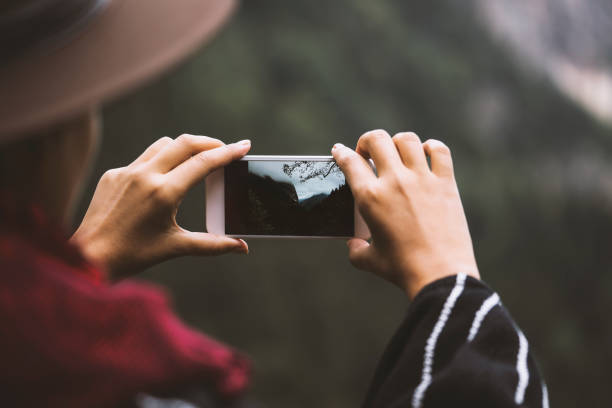 istock Hand taking photo of scenic mountain view 615288068