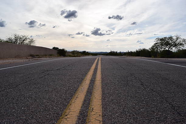 istock Deserted Desert Road into the Mountains 615384586