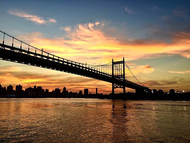 istock Silhouette of Triborough bridge with sunset sky 615386966