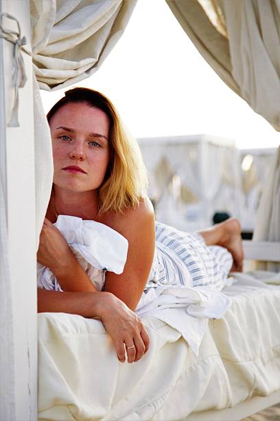 istock young beautiful woman sunbathing in the beach 615387938