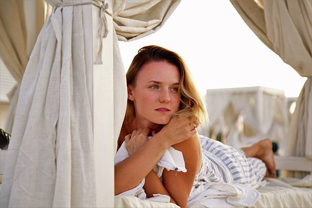 istock young beautiful woman sunbathing in the beach 615387952