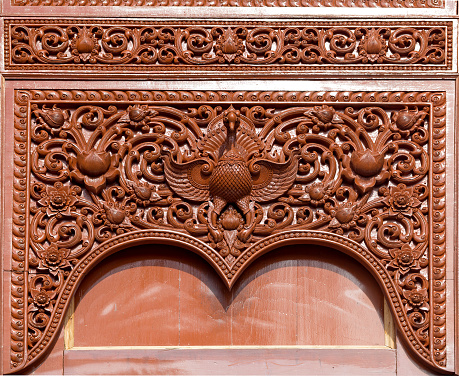 Carved wooden door detail of bird