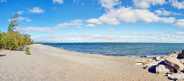 A panorma looking down the west side of Lake Ontario waterfront in Hamilton, Ontario, Canada at Confederation Park and Van Wagner's beach on a warm autumn day.