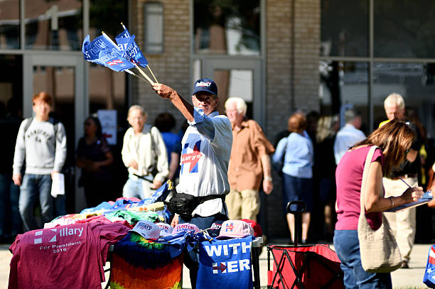 Bill Clinton Rallies for Hillary Clinton in Pennsylania Blue Bell, Pennsylvania, USA - October 18, 2016: Outside a Hillary Clinton rally in suburban Philadelphia, PA, a vendor offers merchandise in support of the Democratic presidential candidate. hillary clinton stock pictures, royalty-free photos & images