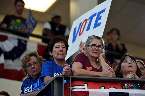 Blue Bell, Pennsylvania, USA - October 18, 2016: Voters are seen listening to former President Bill Clinton in the Philadelphia, Pennsylvania suburbs during a Stronger Together campaign rally in support of his wife Hillary Clinton, the Democratic presidential nominee in the race for the 2016 U.S. Presidential Elections.