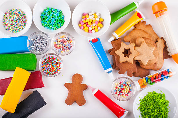 Decorating gingerbread man Christmas cookie with red icing