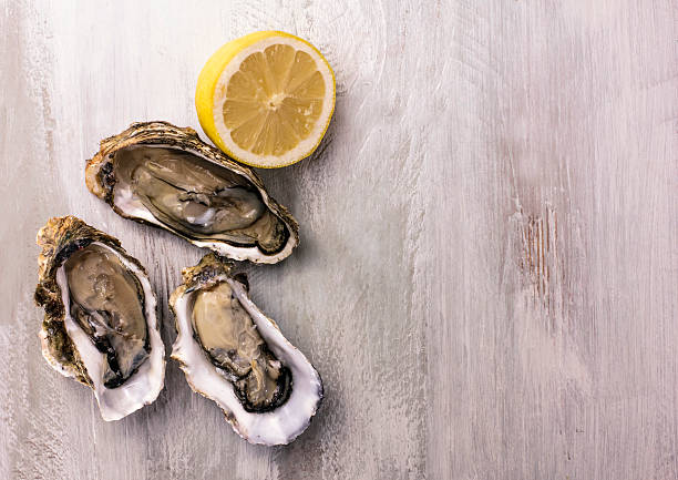 istock Freshly shucked oysters with lemon and copyspace 615392180