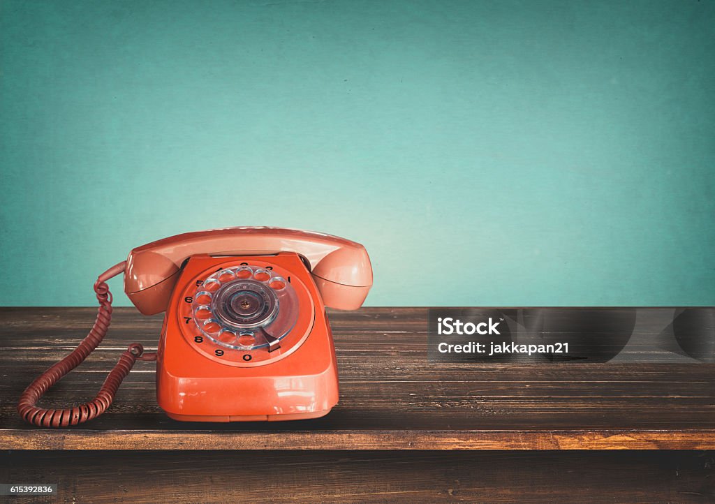 retro telephone Old retro red telephone on table with vintage green pastel background Telephone Stock Photo