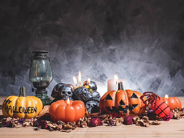 istock Halloween pumpkins with candlelight and skulls on dark background. 615393442