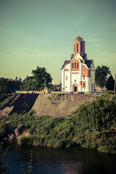 istock Christian church on a hill by the river 615394660