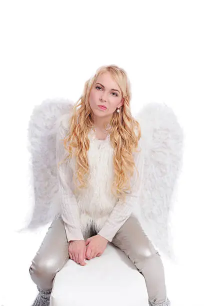 attractive woman with big angelwings in a bad mood