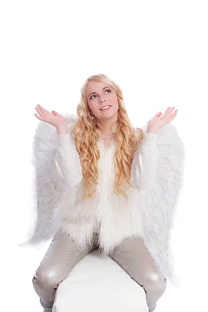 attractive woman with big angelwings holding hands up