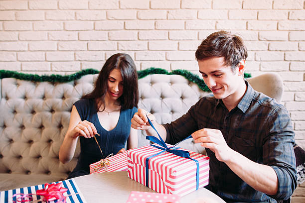 istock Happy couple unpacking xmas presents 615395668
