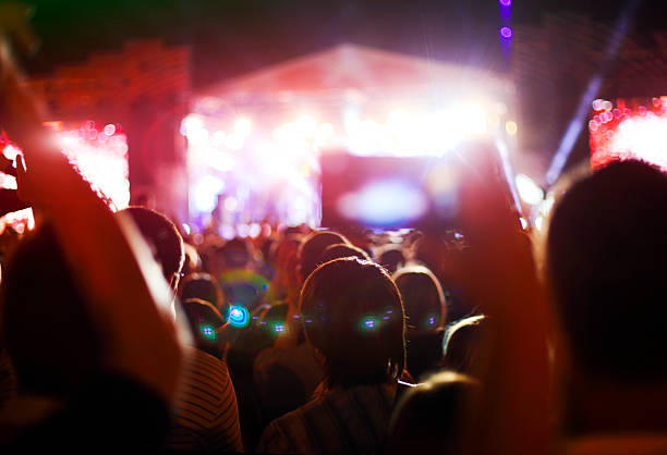 istock Concert crowd in front of bright stage lights 615396062