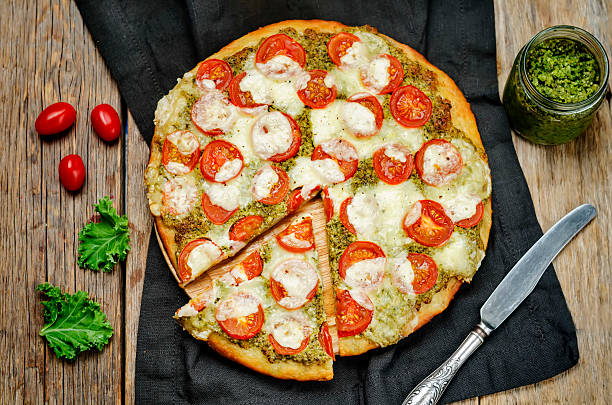 istock tomato mozzarella kale pesto pizza 615396432