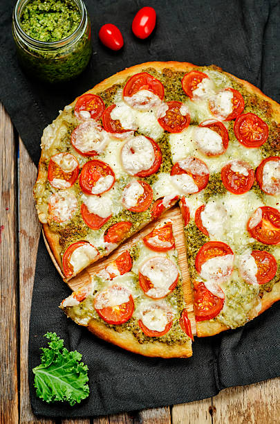 istock tomato mozzarella kale pesto pizza 615396438