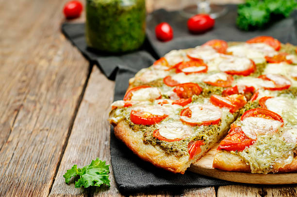 istock tomato mozzarella kale pesto pizza 615396440