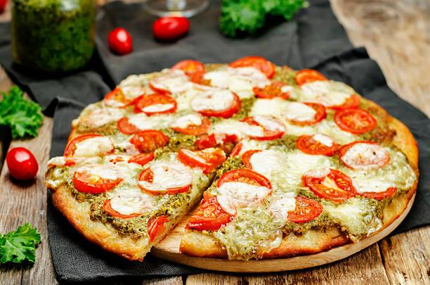 istock tomato mozzarella kale pesto pizza 615396446