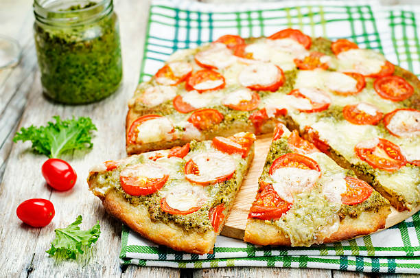 istock tomato mozzarella kale pesto pizza 615396484