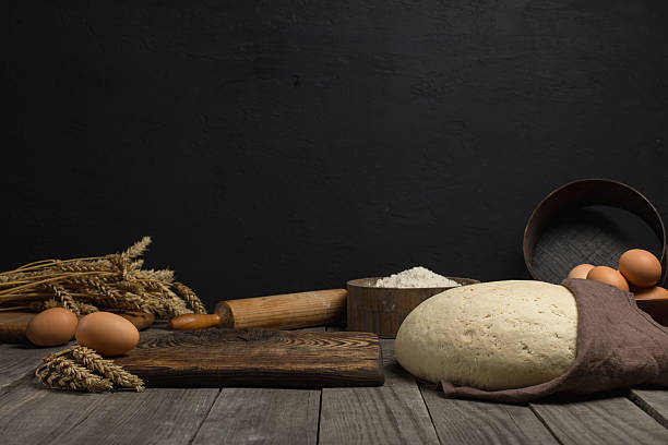 istock Dough with ingredients for cooking dough on wooden table 615396826