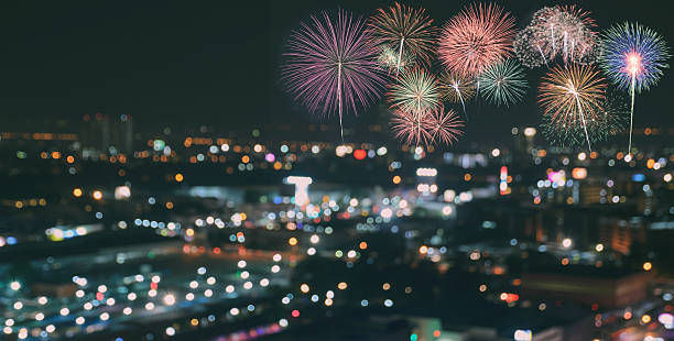 istock Colorful fireworks on blur city skyline background at night 615397040