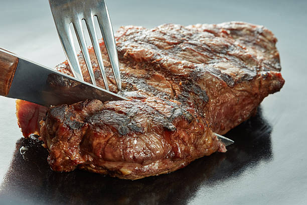 istock Macro of grilled meat on dark 615397832