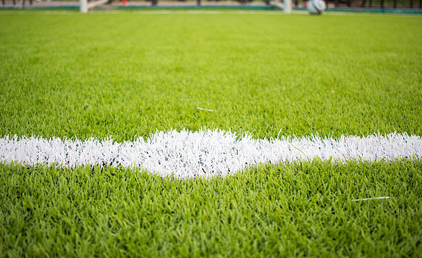 istock Artificial turf football field green white grid 615398736