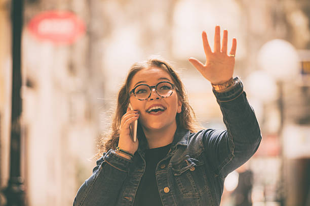istock Smiling beautiful woman using cellphone outdoors. 615403046