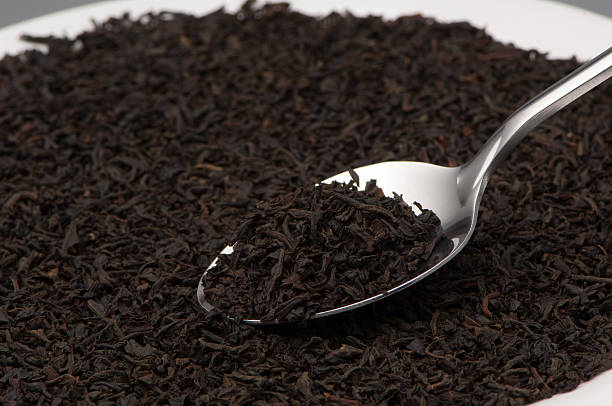 istock spoon with tea leaves close-up 615403218