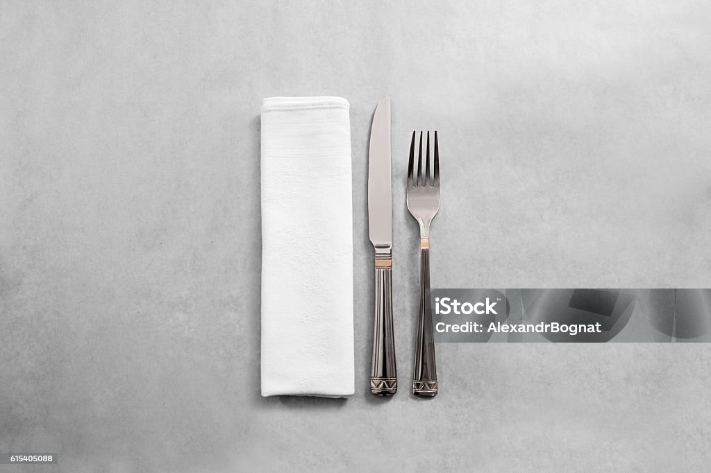 Blank white restaurant napkin mock up with fork and knife, Blank white restaurant napkin mock up with fork and knife, isolated. Cutlery near clear textile towel mock up template. Cafe branding identity clean napkin surface for restaurant logo design branding. Tablecloth Stock Photo