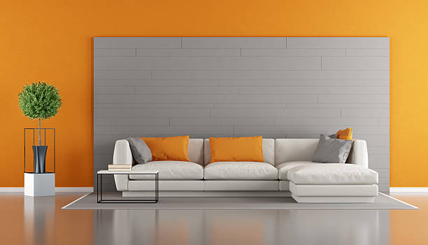 istock Gray and orange modern living room 615406794