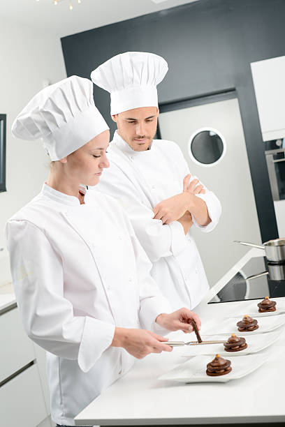 istock student and teacher professional cook school kitchen preparing chocolate dessert 615409004