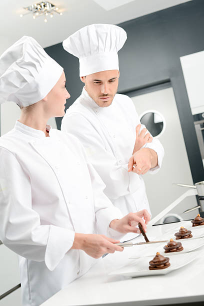 istock student and teacher professional cook school kitchen preparing chocolate dessert 615409164