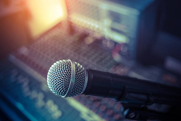 istock Microphone over the Abstract blurred on sound mixer 615409200