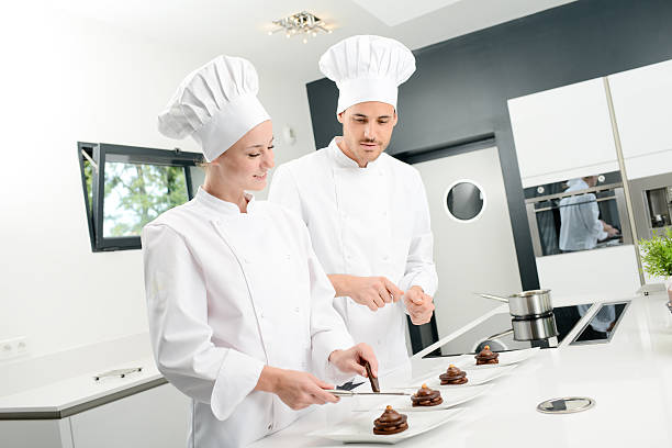istock student and teacher professional cook school kitchen preparing chocolate dessert 615409310