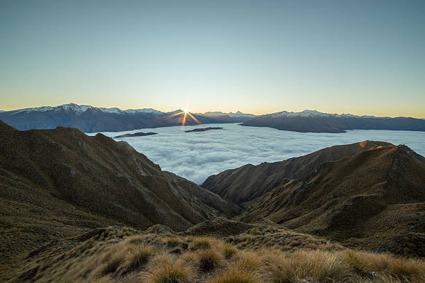 istock Last sun over the clouds from mountain peak 615409568