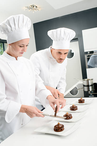 istock student and teacher professional cook school kitchen preparing chocolate dessert 615409670