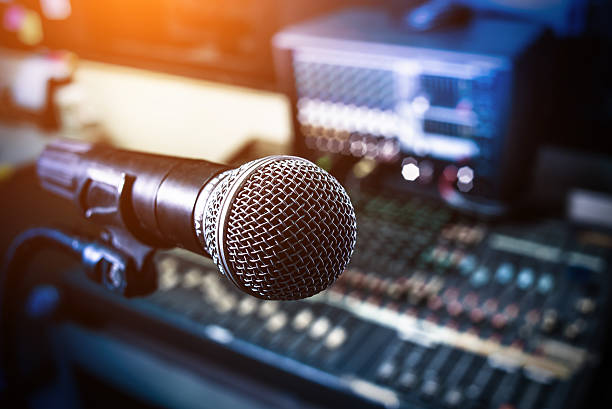 istock Microphone over the Abstract blurred on sound mixer 615409790