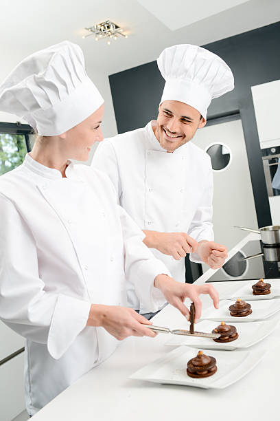 istock student and teacher professional cook school kitchen preparing chocolate dessert 615409842