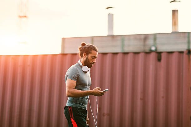 istock Athletic Man Using Smart Phone Outdoors. 615409916