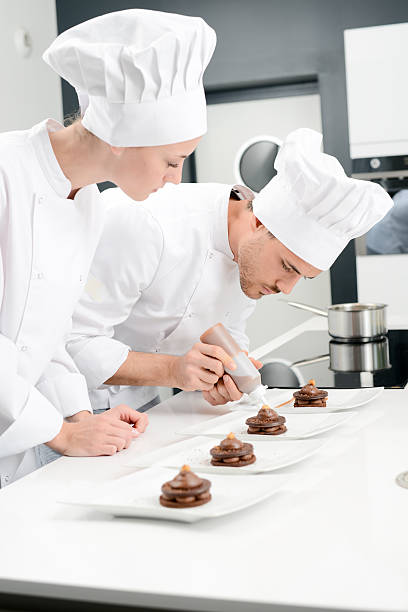 istock student and teacher professional cook school kitchen preparing chocolate dessert 615410022